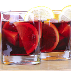 Two tall drinking glasses filled with Heavenly Hibiscus Sangria "Mocktail"