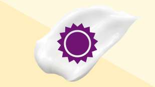 two toned yellow background with a white cream smear on top with a purple sun on top of the cream