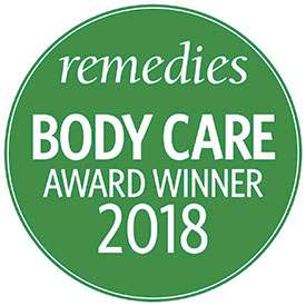 Green circle logo with white lettering that reads Remedies Body Care Award Winner two thousand eighteen