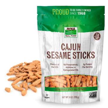 bad of cajun sesame sticks with sticks loose on table behind the bag