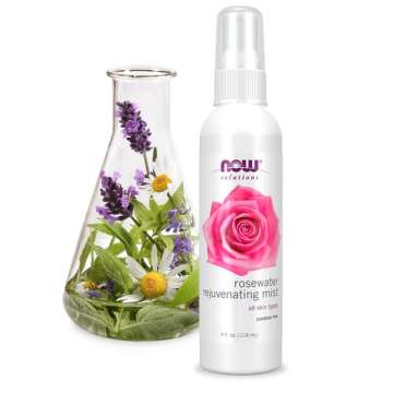 Bottle of NOW Solutions Rosewater Rejuvenating Mist with a glass beaker with flowers and herbs inside it