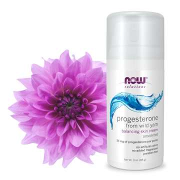 Bottle of NOW Solutions Progesterone with pink flower next to it
