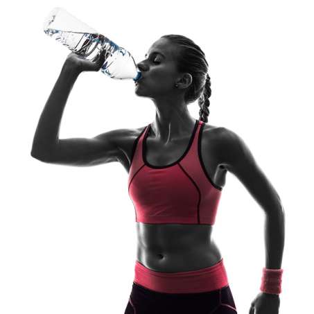 female presenting person drinking water after working out