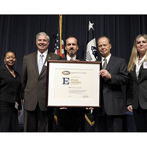 Framed award presented with five people dressed in business suits.