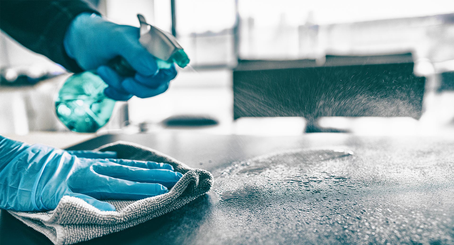 blue spray bottle, cleaning counter wearing blue rubber gloves