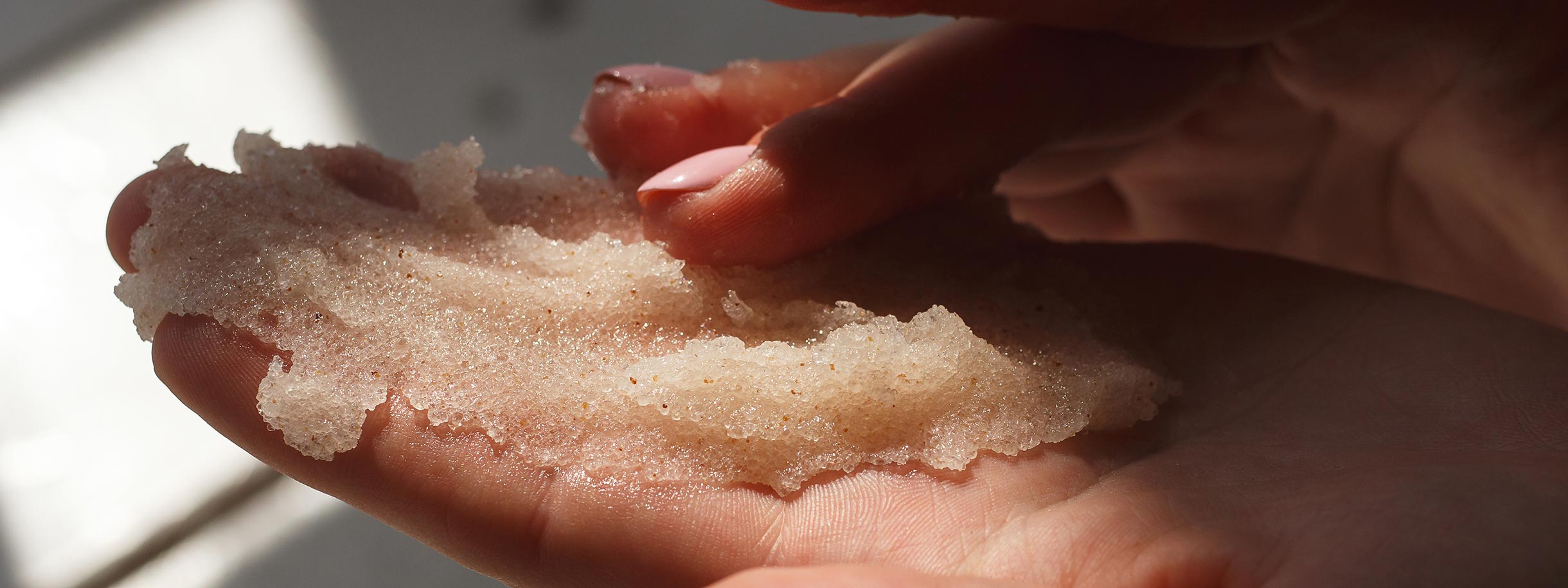 Sugar scrub in light skinned hands