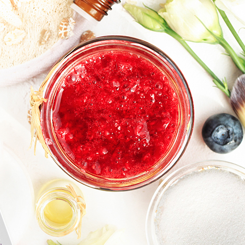 top view of freedom rings sugar scrub with coconut oil and sugar surrounding it