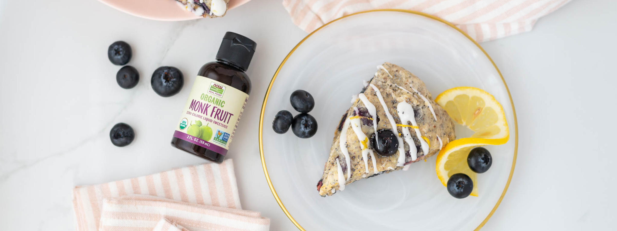 top view of Lemon Poppyseed Scones with bottle of liquid monk fruit next to it