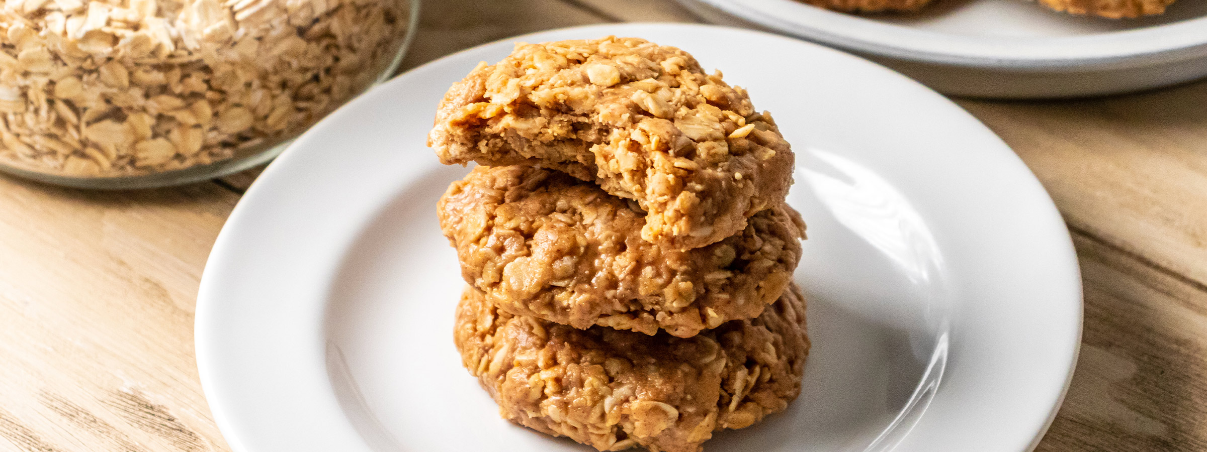 three no bake peanut butter oatmeal cookies stacked on top of each other on a white plate