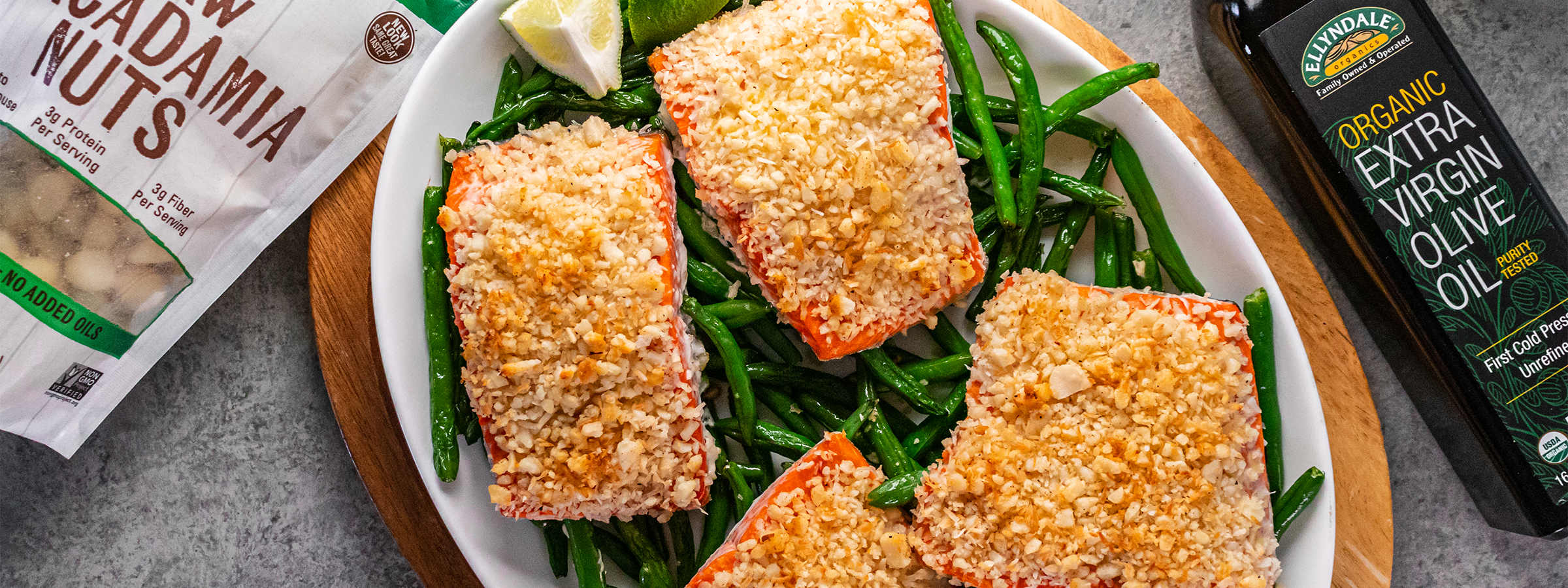 top view of Sheet Pan Macadamia Nut Crusted Salmon and Green Beans between macadamia nuts and extra virgin olive oil