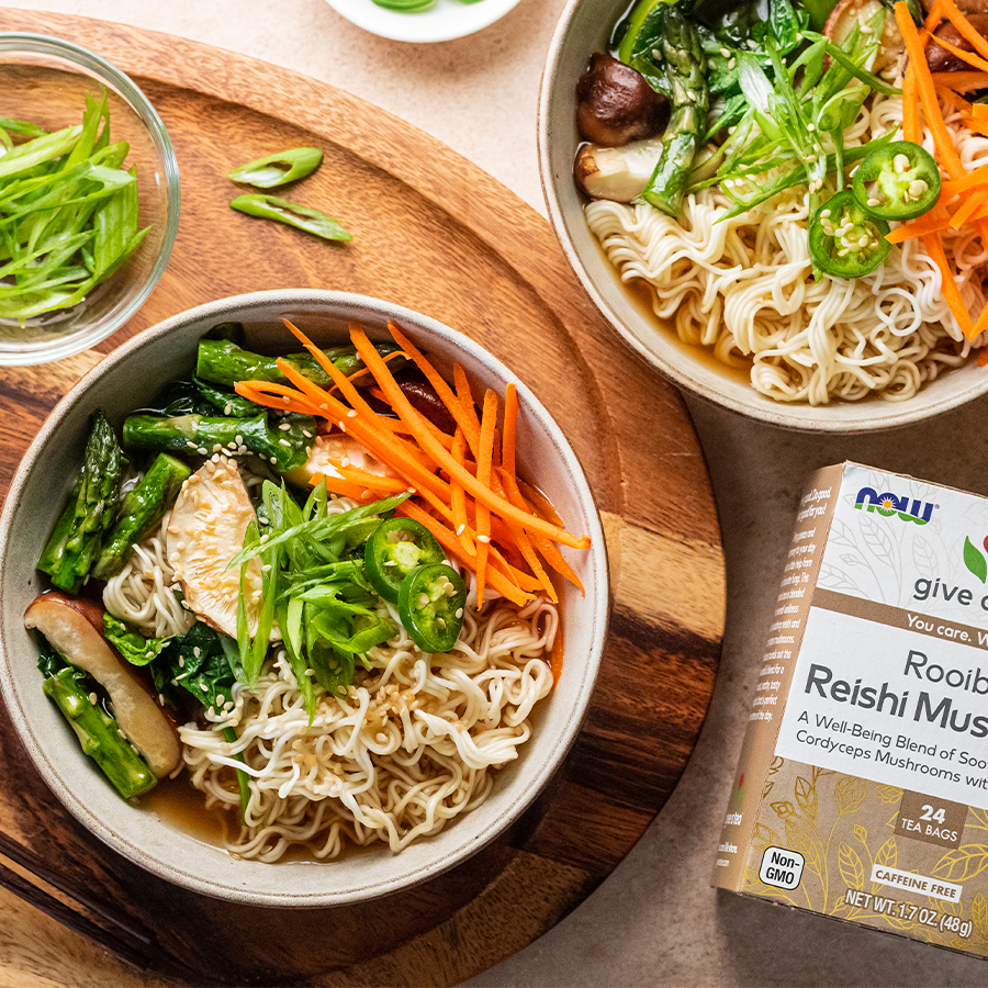 top view of a bowl of Plant Based Ramen with Rooibos Tea next to a box of NOW Rooibos Tea