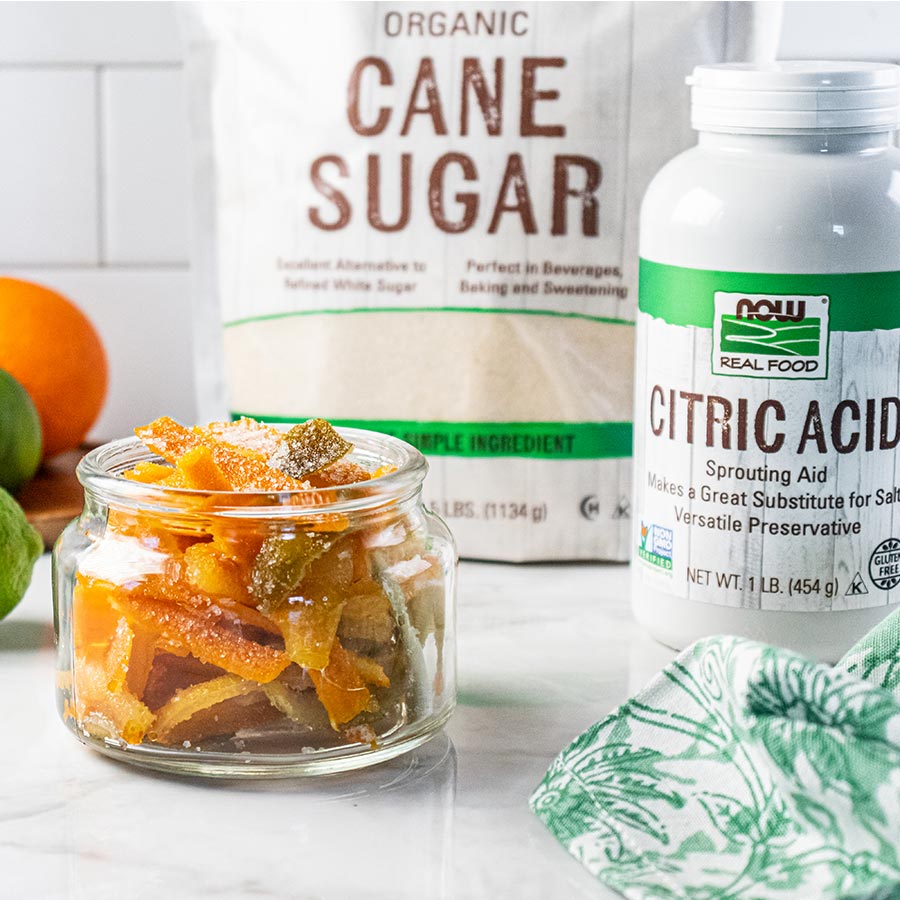 jar of candied citrus peels, bag of Organic Cane Sugar, NOW Real Foods Citric Acid