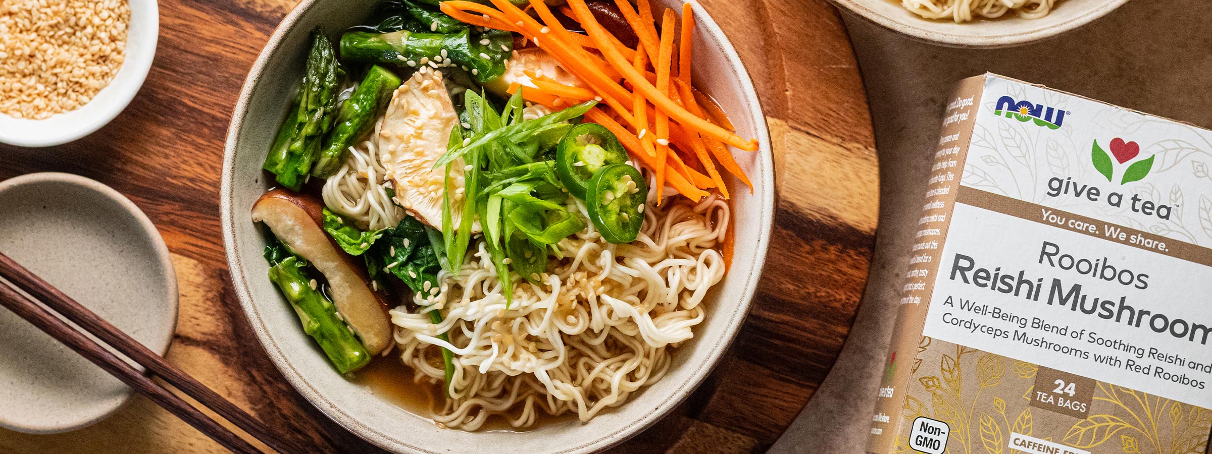 top view of a bowl of Plant Based Ramen with Rooibos Tea next to a box of NOW Rooibos Tea