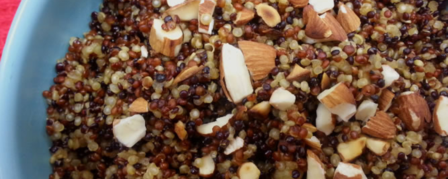 A closeup of Curried Quinoa with Toasted Almonds in a blue bowl