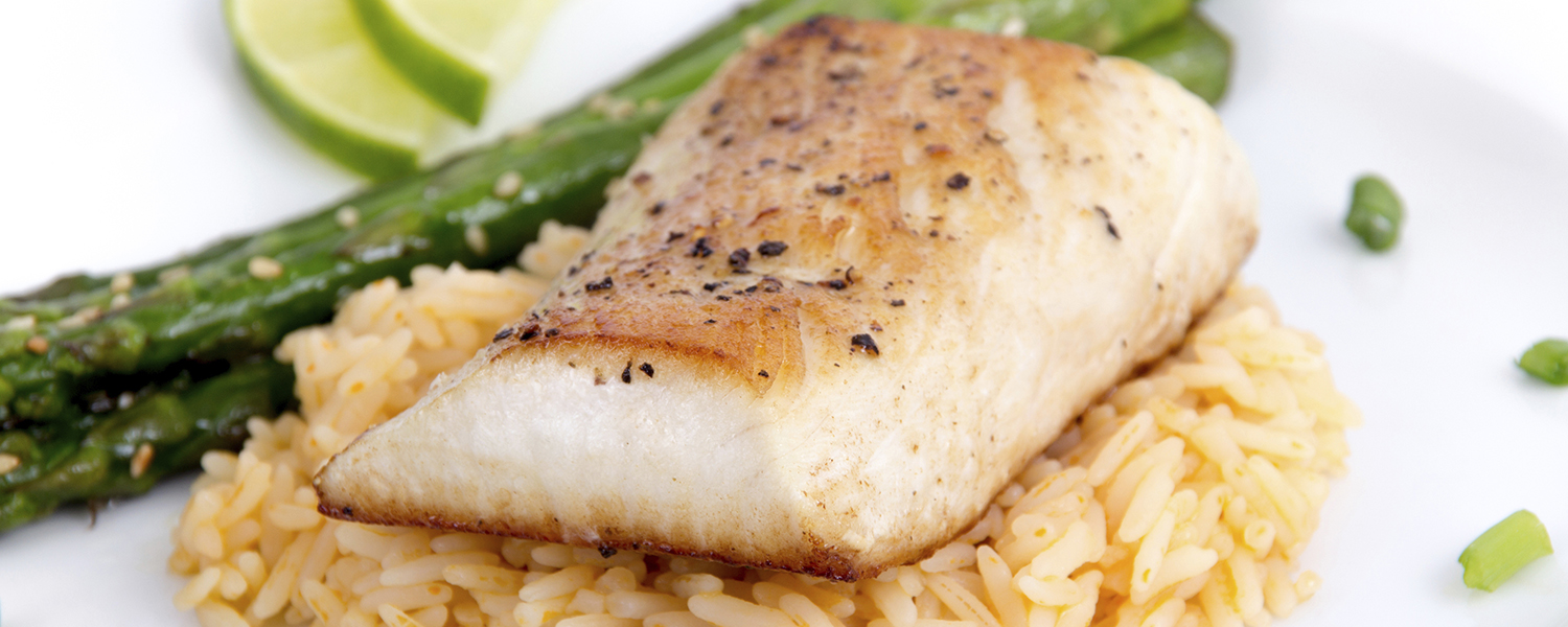 A closeup of a white ceramic plate with Ginger Glazed Mahi Mahi on Sprouted Brown Rice