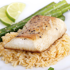 A closeup of a white ceramic plate with Ginger Glazed Mahi Mahi on Sprouted Brown Rice