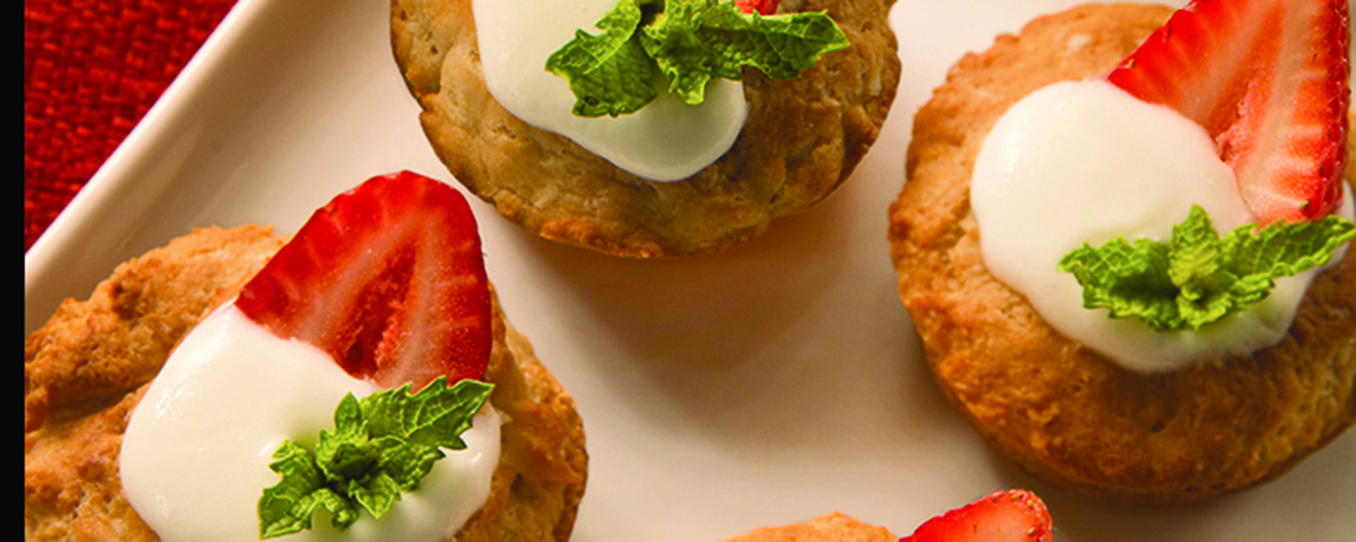 A closeup of a white ceramic platter holding several Gluten Free Strawberry Shortcakes