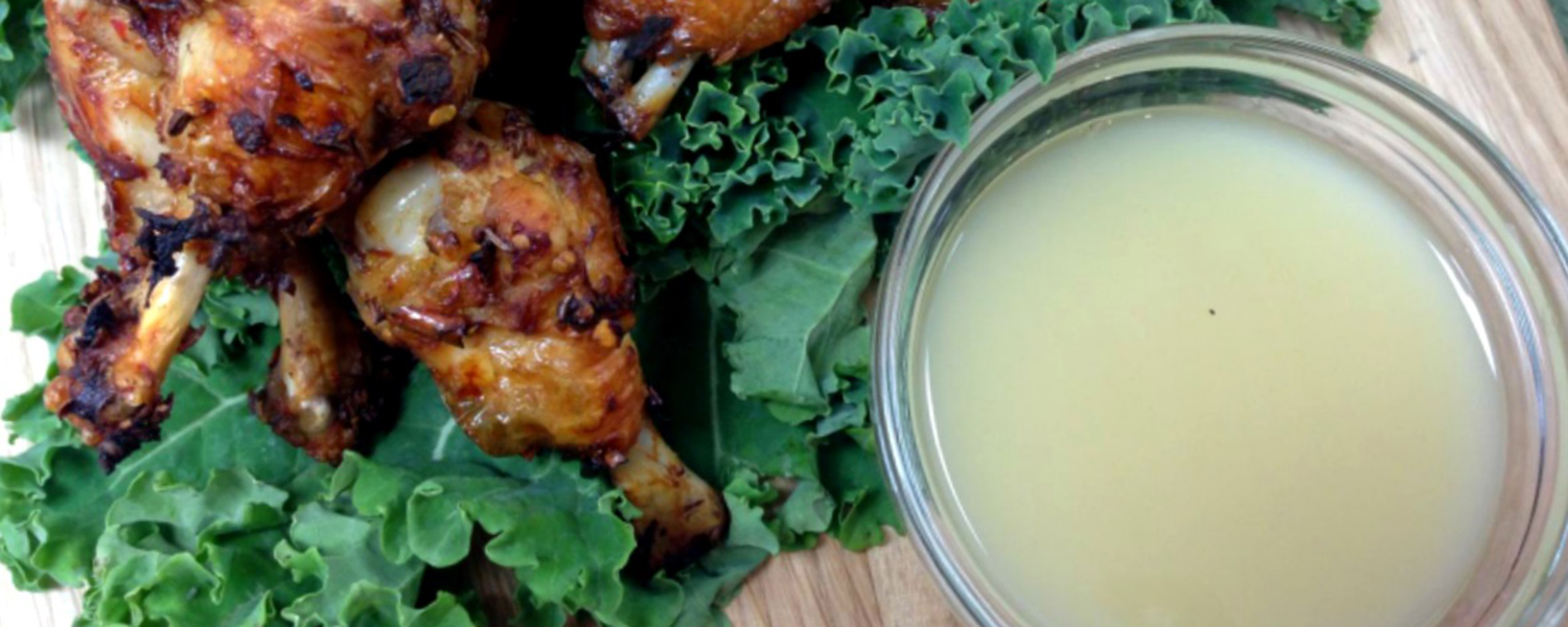 A small dipping dish on a wooden platter is filled with Sweet Lemon Mustard Sauce