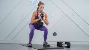 Danielle Pascente squatting holding dumbell