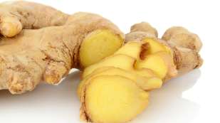 A sliced open ginger root placed on a white counter.