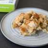 baked cauliflower and cheese on a white plate on a dark table and a partial view of box of NOW pasta behind the plate