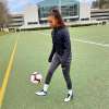 Ally Watt kicking a soccer ball on field