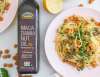 bowl of lemon caper pasta next to a bottle of ellyndale macadamia nut oil