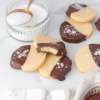 top view of Chocolate-Dipped Shortbread Cookies with bag of monk fruit next to it