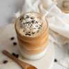 top view of Frozen Amaretto Coffee Latte with a jar of coffee beans next to it