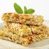 A clear decorative plate is topped with several Chewy Coconut Granola Bars