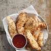 A closeup of several Gluten Free Triple Coconut Chicken Tenders