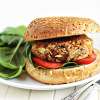 A white ceramic plate holding a Mediterranean Black Bean Veggie Burger