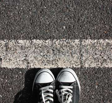 sneakers standing at white line on the blacktop