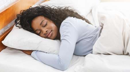 dark skinned female presenting person sleeping