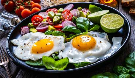 sunny side up eggs on plate with salad