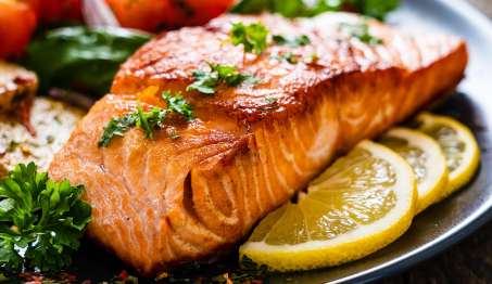 cooked salmon on plate with lemon