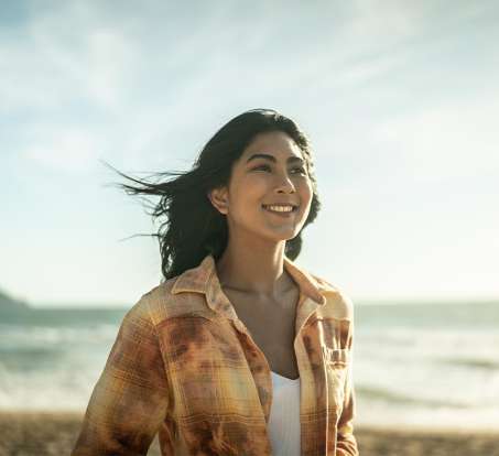 medium skinned female presenting person at the beach