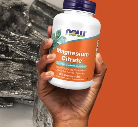 hand holding bottle of NOW Magnesium Citrate