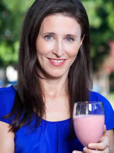 Marie Spano holding a pink smoothie