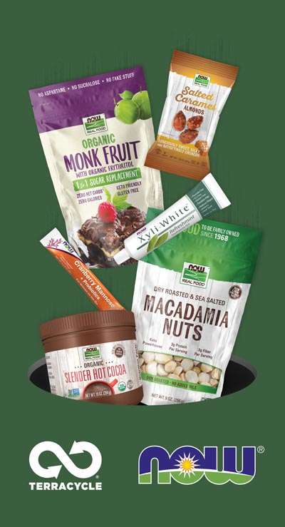 NOW products falling into hole. Salted Carmel Almonds, Monk Fruit bag, Xyliwhite toothpaste, Macadamia Nuts bag, Cranberry Mannose packet, and Slender Hot Cocoa. Terracycle and NOW Logo