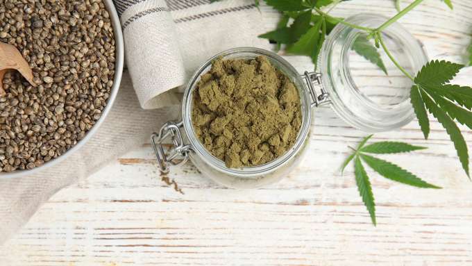 Bowl of Hemp seeds, jar of hemp protein, and few hemp leaves. 