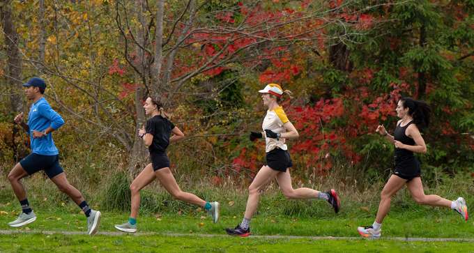 Athletes running on outside trail 