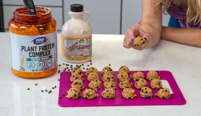 NOW Sports Plant Protein Complete, NOW Maple Syrup with Protein Cookie Dough Balls on counter