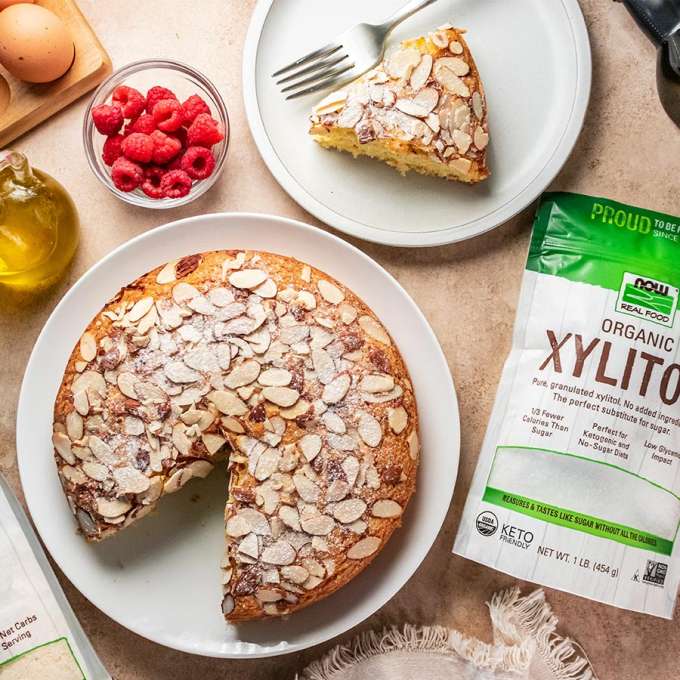 top view of Almond Coconut Cake with NOW Xylitol next to it