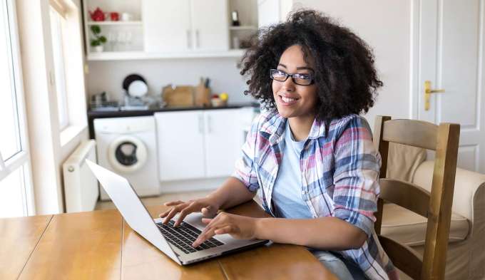 woman sitting at a table working on a computer