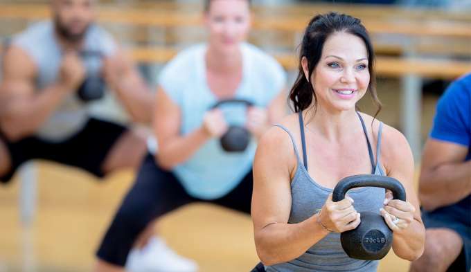 people working out with kettle bells 