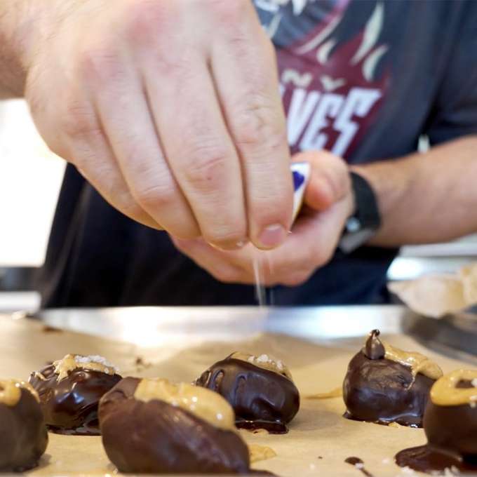 Joe Nardella sprinkling salt on top of truffles