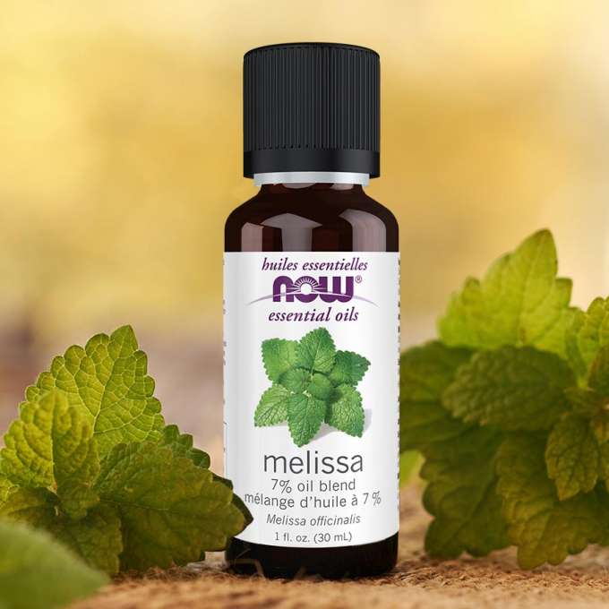 Melissa NOW essential oils with melissa leaves around it