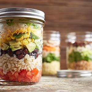 Several mason jars filled with Fiesta Mason Jar Salad