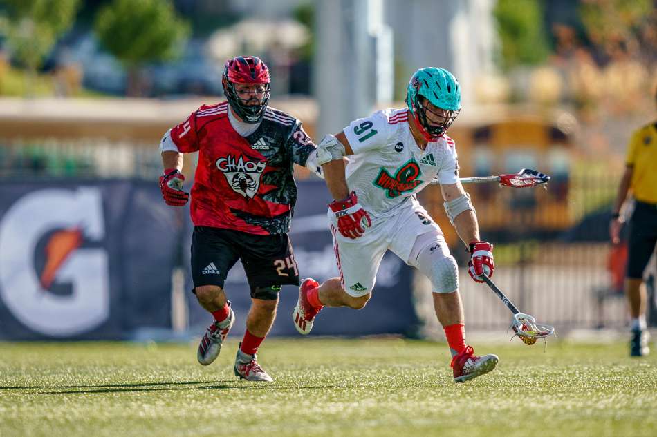 Joe Nardella playing lacrosse with a defender close by